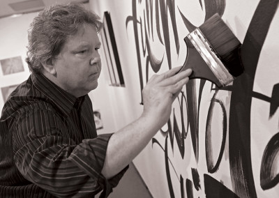 John Stevens doing large wall brush calligraphy at Wake Forest University
