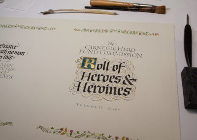 Title page for Roll of Heroes and Heroines of Carnegie Fund Commission with illuminated scroll and dropcap. Calligraphy Hand Lettering by John Stevens
