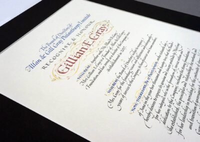 A hand-lettered Resolution that is written out and also decorated with gold leaf.
