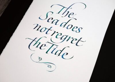 A short quote calligraphy on paper by John Stevens, using blue and green water colors.