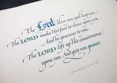 Prayer written out in Italic calligraphy with gold.