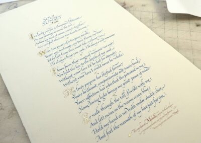 Poem rendered in fine, pen-written Italic calligraphy with 23k gold initials and dedication in red. Arches paper.